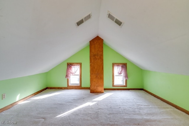 additional living space with light carpet and lofted ceiling