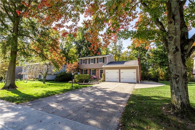 view of front of property with a front yard and a garage