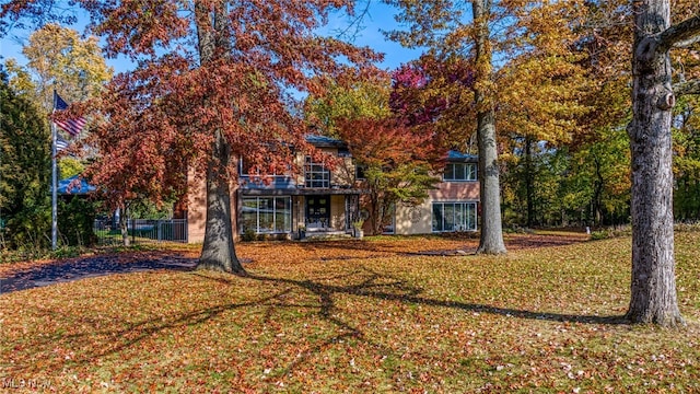 rear view of house with a yard