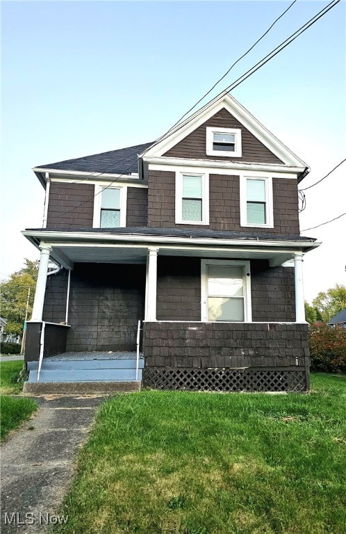 view of front of house featuring a front yard and a porch