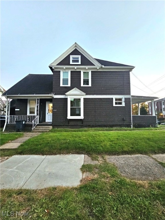 view of front of house featuring a porch and a front yard