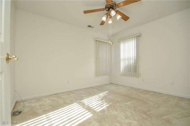 unfurnished room featuring ceiling fan and light colored carpet