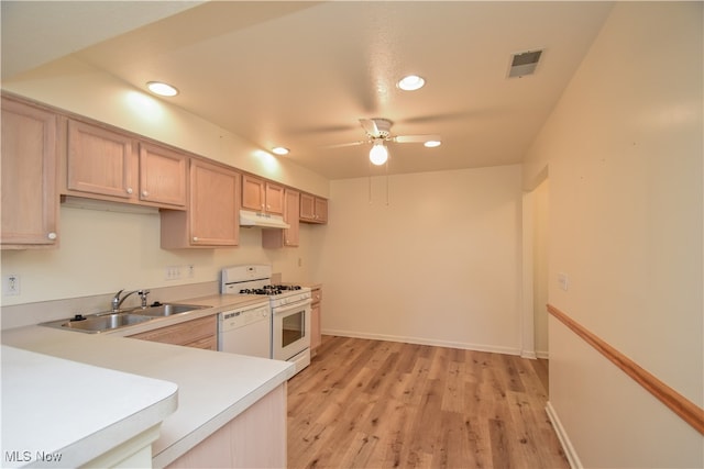 kitchen with light brown cabinets, light hardwood / wood-style flooring, sink, white appliances, and ceiling fan