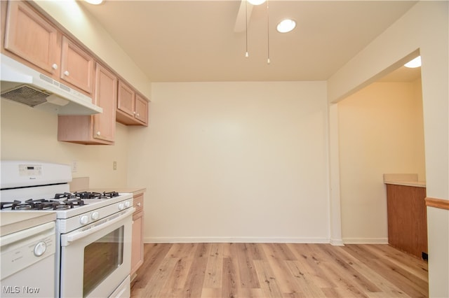 kitchen with light hardwood / wood-style floors, light brown cabinetry, and white appliances