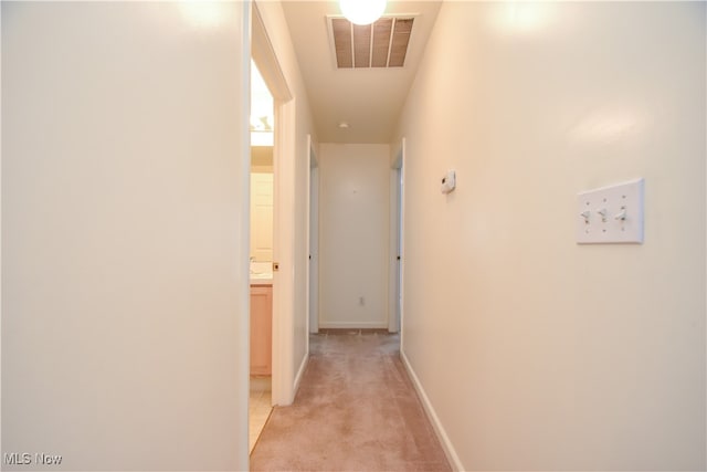 hallway with light colored carpet