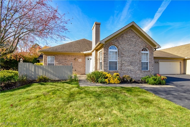 view of front of property with a front lawn and a garage