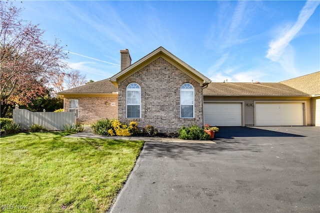 view of front of property with a garage and a front lawn