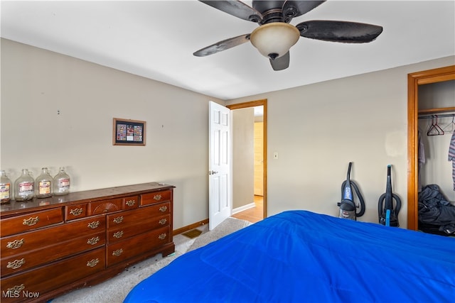 bedroom with light carpet, a closet, and ceiling fan