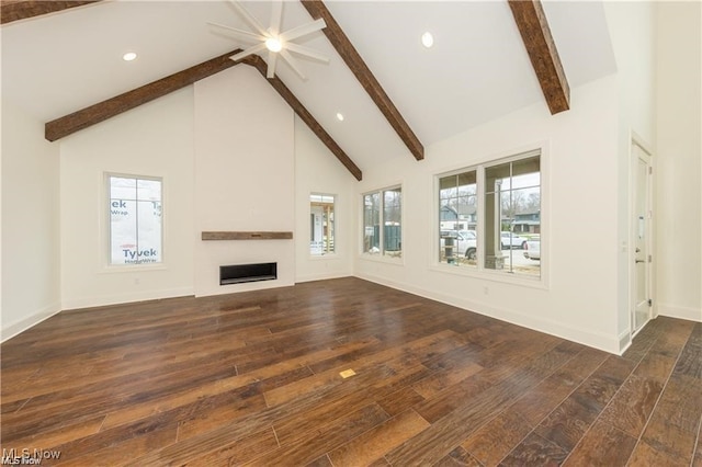 unfurnished living room with beamed ceiling, dark wood-type flooring, and high vaulted ceiling