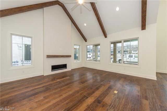 unfurnished living room featuring a fireplace, dark hardwood / wood-style floors, high vaulted ceiling, and plenty of natural light