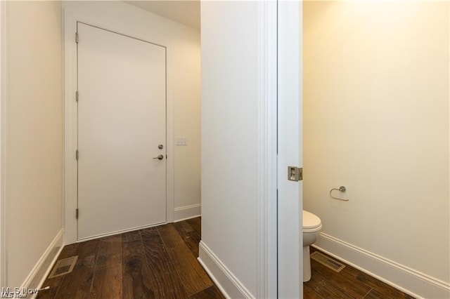 bathroom with hardwood / wood-style flooring and toilet