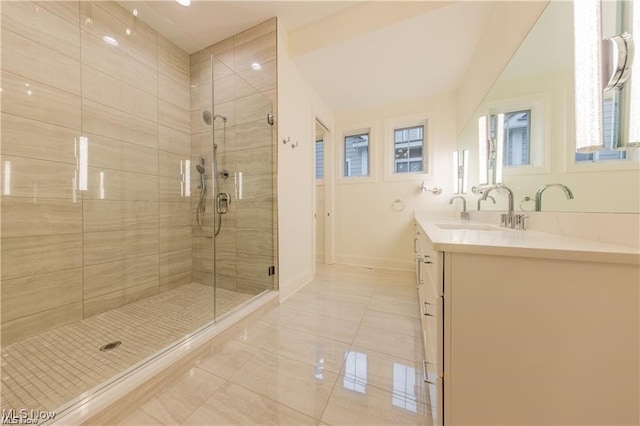 bathroom featuring vanity and a shower with shower door