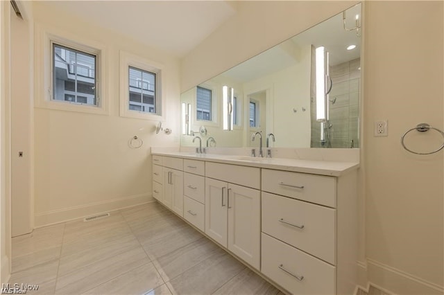 bathroom with vanity, tile patterned flooring, and a shower with door