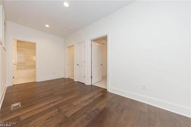 spare room featuring dark hardwood / wood-style floors