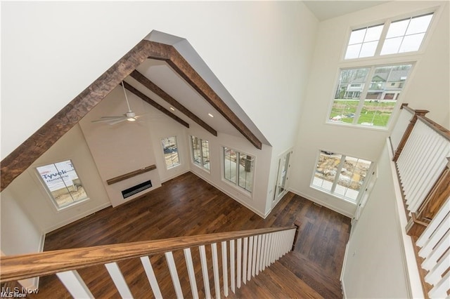 stairs with a towering ceiling and plenty of natural light