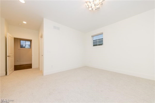 unfurnished room with light colored carpet