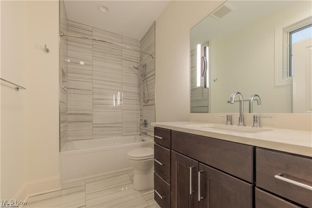 full bathroom with toilet, tiled shower / bath combo, vanity, and plenty of natural light