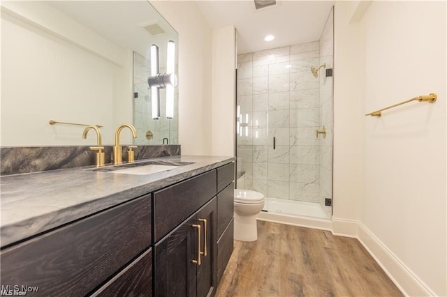 bathroom featuring toilet, walk in shower, vanity, and wood-type flooring