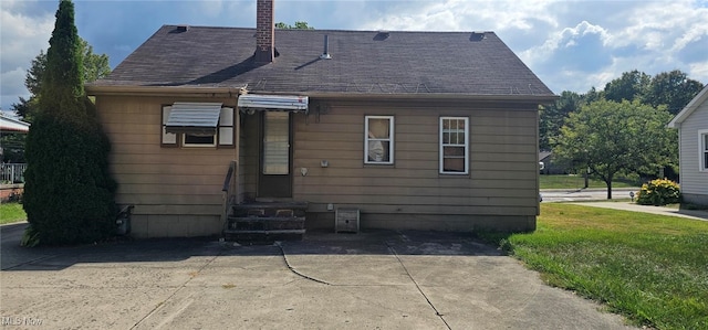 rear view of house with a yard