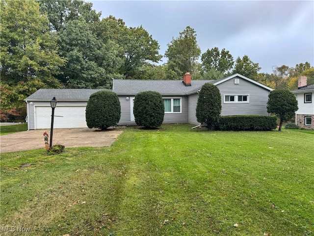 single story home featuring a front yard and a garage