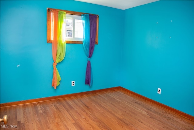 empty room with hardwood / wood-style floors