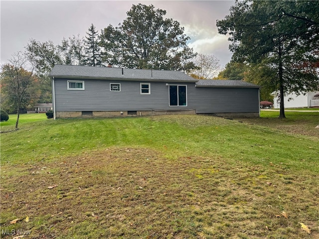 rear view of property with a yard