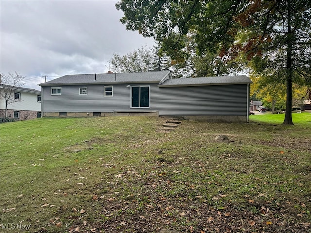 rear view of house with a yard