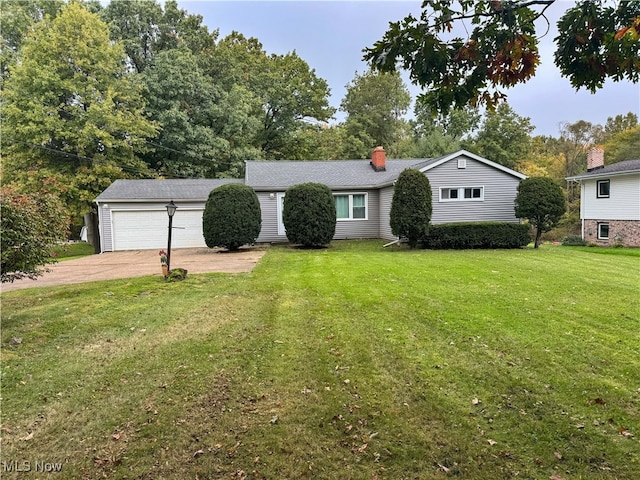 view of front of property with a front yard and a garage