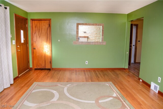 spare room with hardwood / wood-style flooring