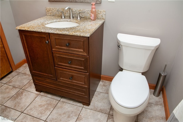 bathroom featuring tile patterned floors, vanity, and toilet