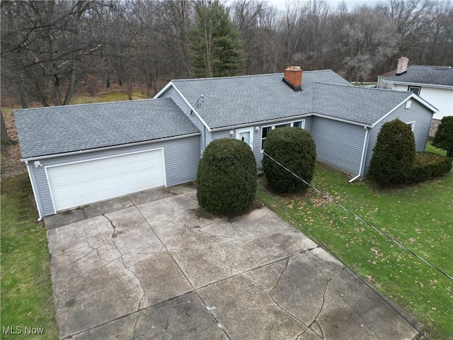 view of front of home with a garage and a front lawn