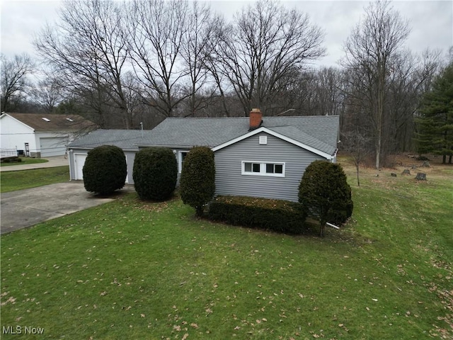 view of home's exterior with a garage and a lawn