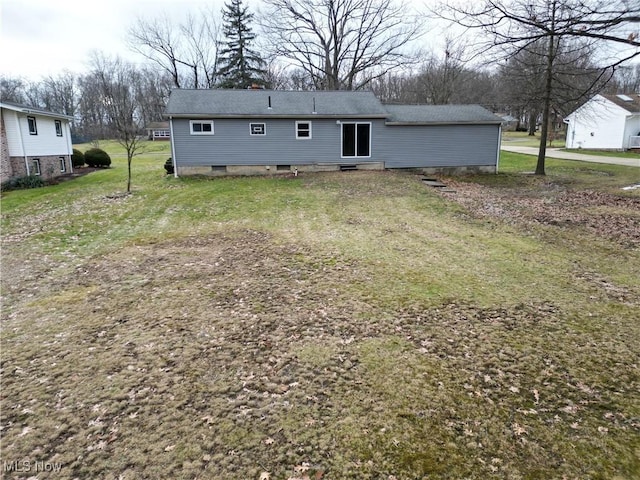 rear view of property featuring a yard