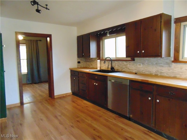 kitchen with sink, light hardwood / wood-style flooring, decorative backsplash, and dishwasher