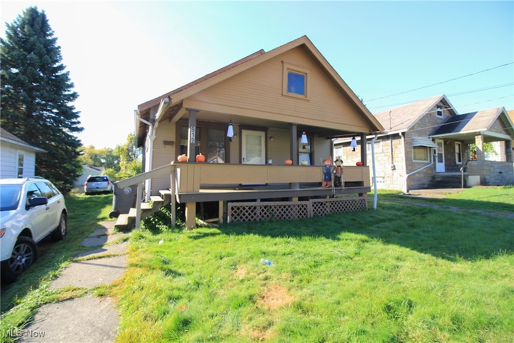 bungalow-style home with a front lawn