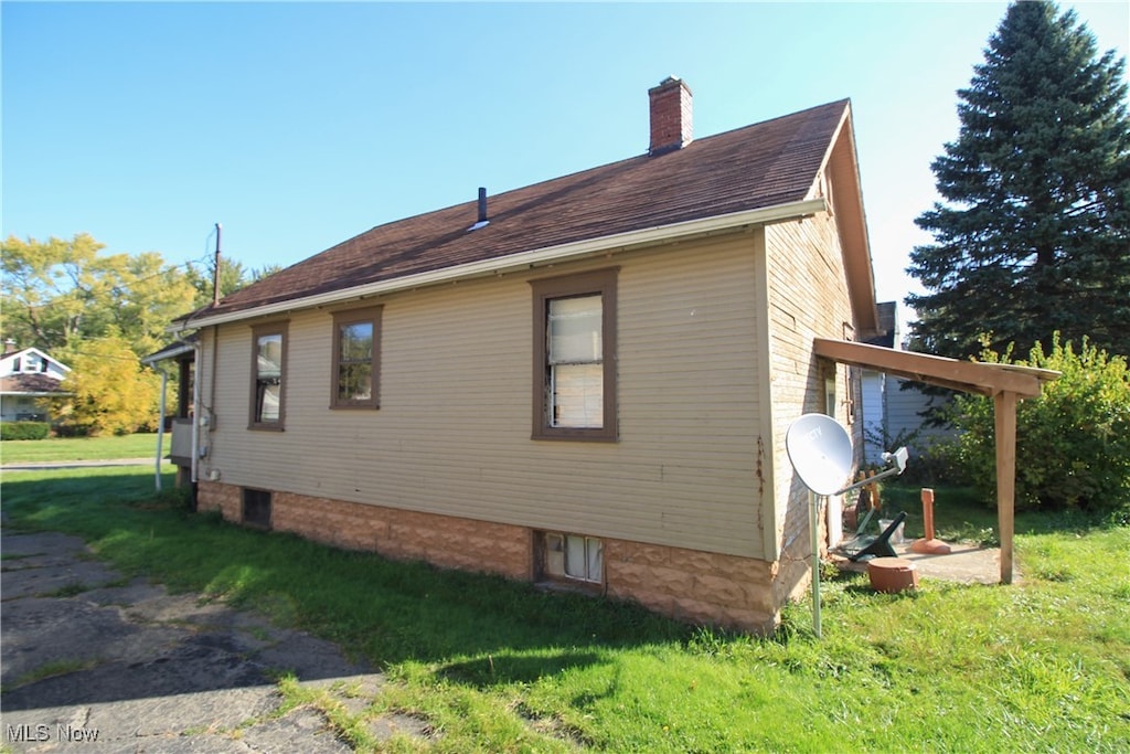 view of property exterior featuring a lawn