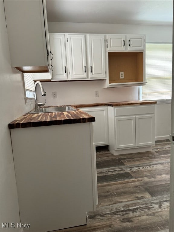 kitchen featuring sink, dark wood-type flooring, and white cabinetry