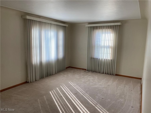 421 W Omar St, Struthers, OH 44471 - carpeted spare room featuring baseboards and a healthy amount of sunlight