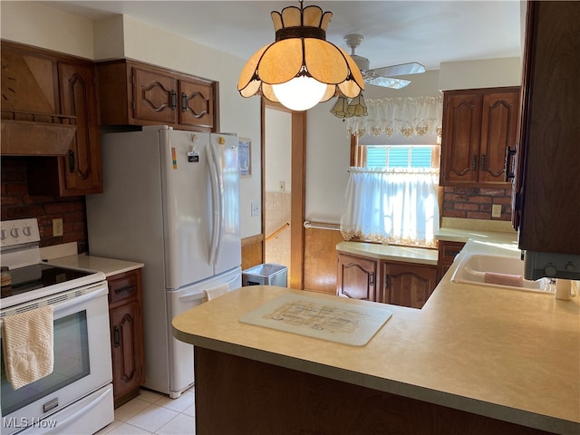 kitchen featuring sink, white appliances, backsplash, and light tile patterned floors