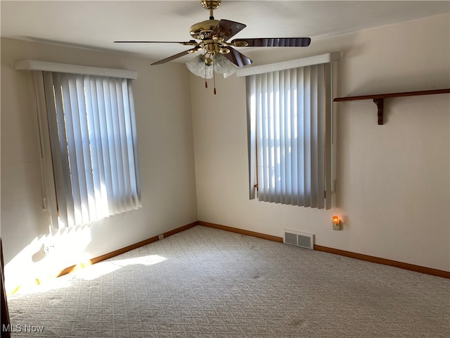 unfurnished room featuring carpet, plenty of natural light, and ceiling fan