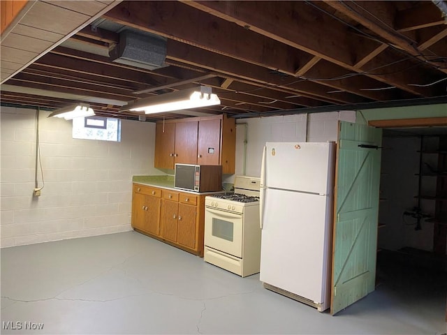 421 W Omar St, Struthers, OH 44471 - kitchen featuring white appliances, finished concrete floors, and brown cabinets