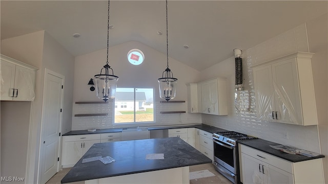 kitchen featuring lofted ceiling, a kitchen island, white cabinetry, pendant lighting, and stainless steel appliances