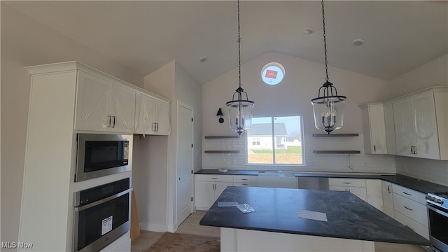 kitchen featuring white cabinetry, appliances with stainless steel finishes, a chandelier, and pendant lighting