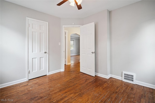 spare room featuring ceiling fan and dark hardwood / wood-style floors