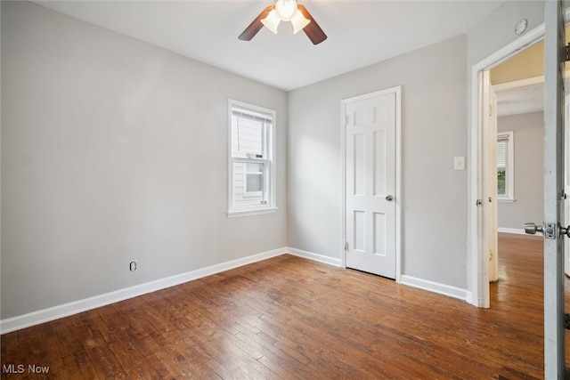 unfurnished bedroom with ceiling fan and dark hardwood / wood-style floors