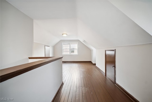 bonus room featuring lofted ceiling and dark hardwood / wood-style flooring