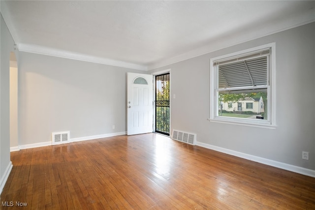 spare room with hardwood / wood-style flooring and ornamental molding