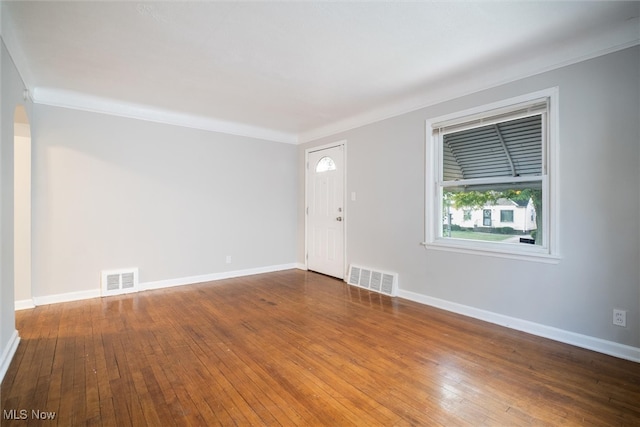 interior space featuring hardwood / wood-style floors and crown molding