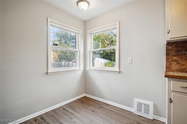 unfurnished dining area with light wood-type flooring