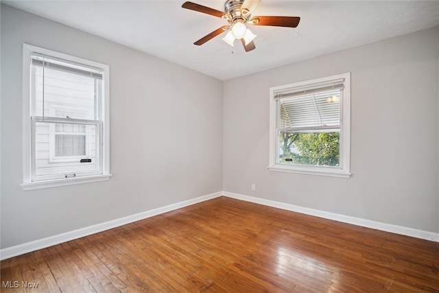 empty room with wood-type flooring and ceiling fan